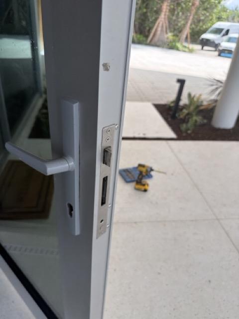 Completed pool door lock project with new French door hardware installed in Longboat Key, Florida
